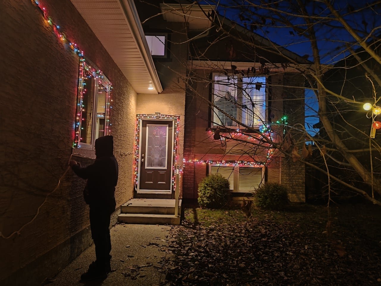 A house adorned with Christmas lights at night.